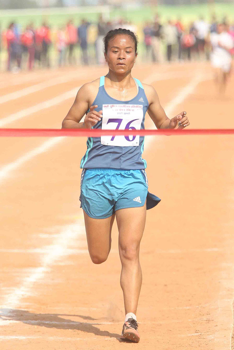 Kanchhi Maya Koju of Nepal APF Club crosses the finish-line in the 5,000m race of the seventh National Games at the Itahari Stadium in Sunsari on Sunday, December 25, 2016. Photo: Udipt Singh Chhetry/THT