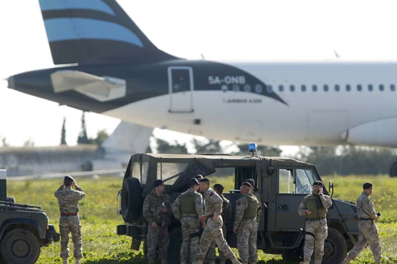 Maltese troops survey a hijacked Libyan Afriqiyah Airways Airbus A320 on the runway at Malta Airport, on Friday, December 23, 2016. Photo: Reuters