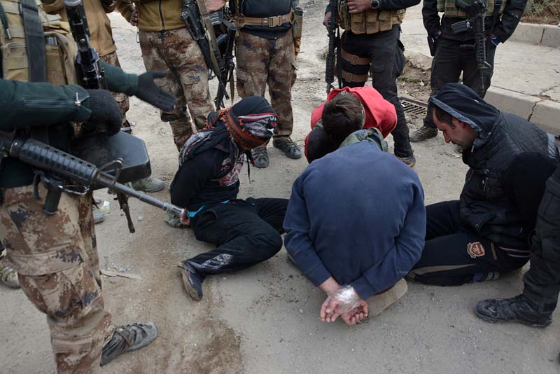 Handcuffed men, who according to the Iraqi security forces are suspected Islamic State militants, are seen in Eelam neighbourhood east of Mosul, Iraq, December 8, 2016. Photo: Reuters