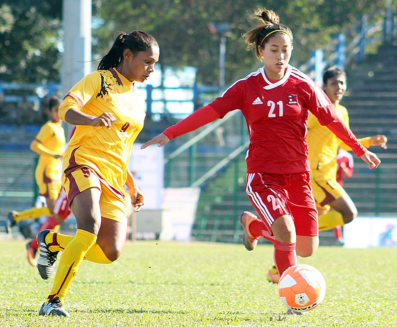 Nepalu2019s Manjali Kumari Yonjan (right) vies for the ball with a Sri Lanka player during their final Group A match of the fourth Womenu2019s SAFF Championship at the Kanchenjunga Stadium in Siliguri, on Friday, December 30, 2016. Photo courtesy: ANFA