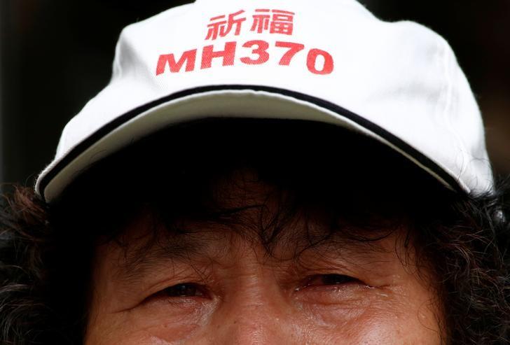 A family member of a passenger aboard Malaysia Airlines flight MH370 which went missing in 2014 reacts during a protest outside the Chinese foreign ministry in Beijing, July 29, 2016.  REUTERS/Thomas Peter
