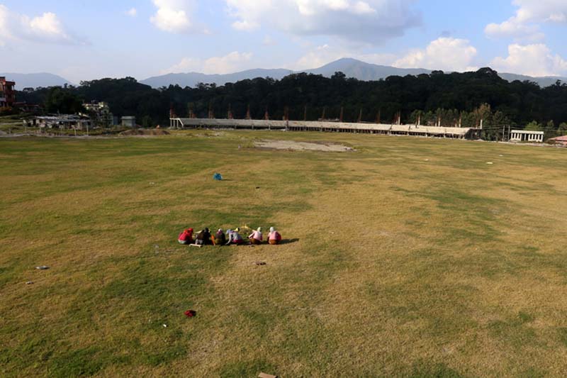 Workers are seen trimming grasses at the under-construction cricket stadium in Mulpani of Kathmandu, on Thursday, December 1, 2016. Photo: RSS 