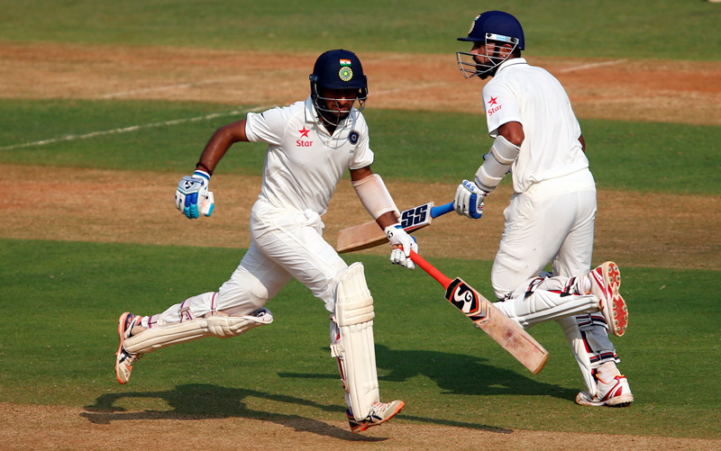 India's Murali Vijay (R) and Cheteshwar Pujara run between wickets. Photo: Reuters