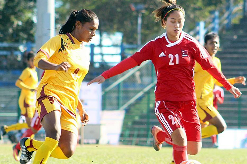 A Nepali player (right) vies for the ball as Nepal play against Sri Lanka during the SAFF Women's Championship, in Siliguri of India, on Friday, December 30, 2016. Photo: ANFA