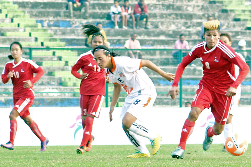 Nepal's Sabitra Bhandari dribbles past a Bhutanese player during the Fourth Women's SAFF Championship, in Siliguri of India, on Monday, December 26, 2016. Photo: ANFA