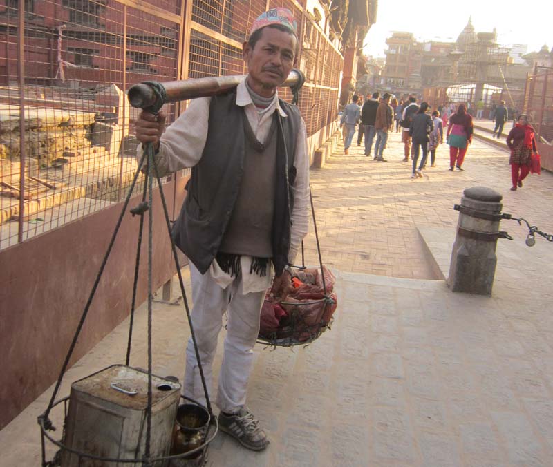 A vendor walks around the Patan Durbar Square to sell oil on Sunday, December 11, 2016. Photo: RSS