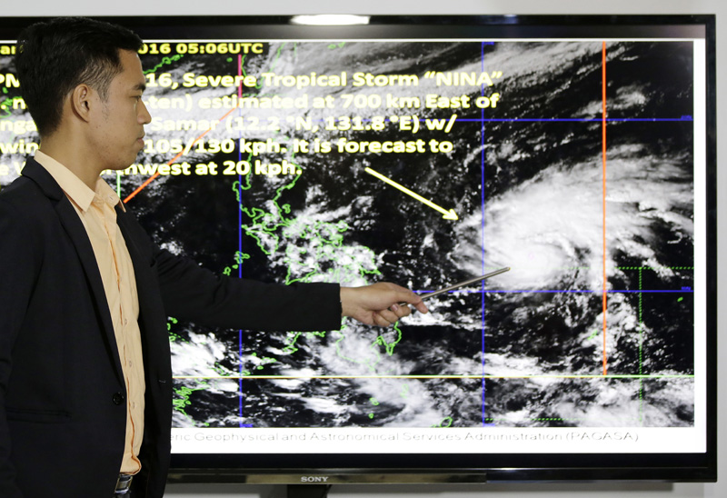 Weather specialist Benison Estareja shows the track of Tropical Storm Nock-Ten during a press conference in Quezon city, north of Manila, Philippines on Friday, December 23, 2016. Photo: AP