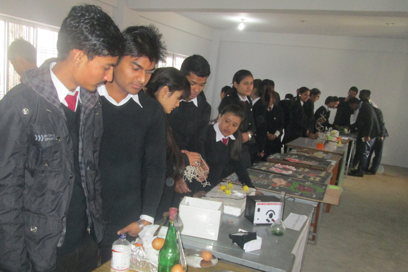 Students observe various scientific equipment and inventions at an exhibition at the Kalika Multiple Campus in Pokhara of Kaski, on Tuesday, December 27, 2016. Photo: Rishi Ram Baral