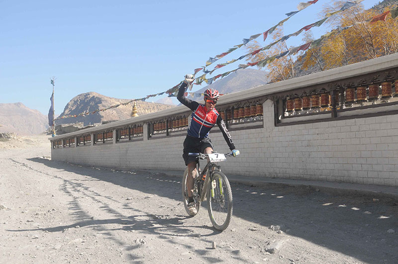 Raj Kumar Shrestha celebrates after winning the sixth stage of the Mustang Madness, a cross country mountain bike race, in Mustang on Wednesday, November 30, 2016. Photo Courtesy: Adventure Sports Nepal