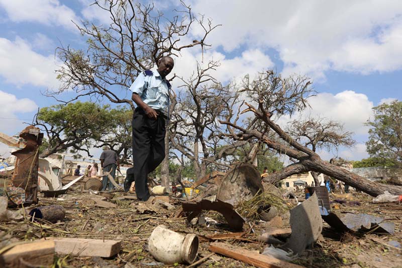 A security officer walks past a temporary stall destroyed after a suicide car bomb went off at the entrance of Somalia's biggest port in its capital Mogadishu, on Sunday, December 11, 2016. Photo: Reuters