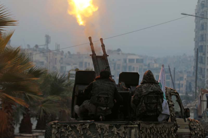 Free Syrian Army fighters fire an anti-aircraft weapon in a rebel-held area of Aleppo, Syria, on December 12, 2016. Photo: Reuters