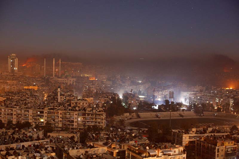 Smoke and flames rise after air strikes on rebel-controlled besieged area of Aleppo, as seen from a government-held side, in Syria, on Sunday, December 11, 2016. Photo: Reuters