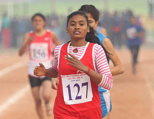 Barefoot athlete Seema Kumari Chaudhary of Far-western Region approaches at finish line and secured bronze medal in women's 800m final race during the 7th National Games at Itahari Rangasal in Sunsari district on Monday, December 26, 2016. Photo: Udipt Singh Chhetry