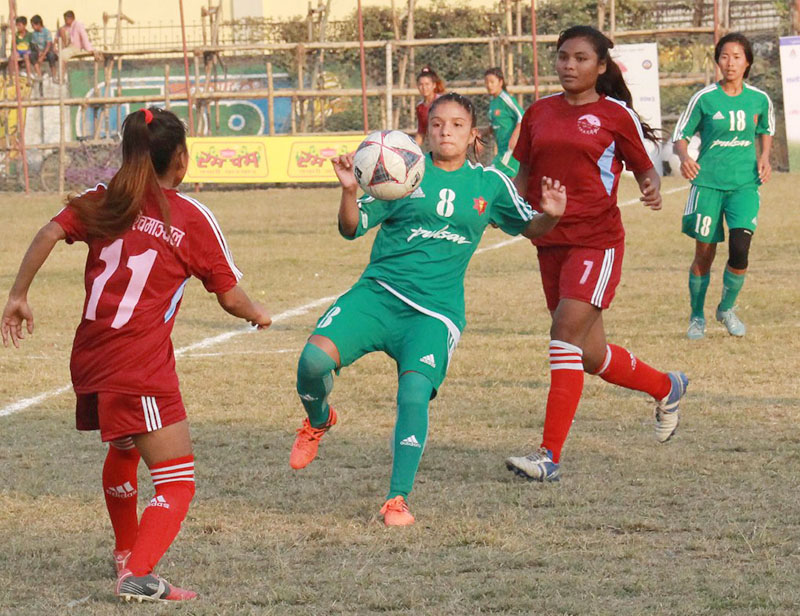 Players of TAC (centre) and Mid-western Region vie for the ball during their womenu2019s football tournament match of the seventh National Games in Sunsari on Sunday, December 18, 2016. Photo courtesy: NSC