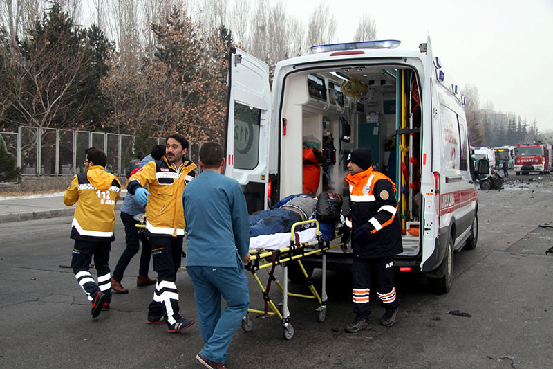 A wounded man is carried to an ambulance after a bus was hit by an explosion in Kayseri, Turkey, on December 17, 2016. Photo: Dogan News Agency via Reuters