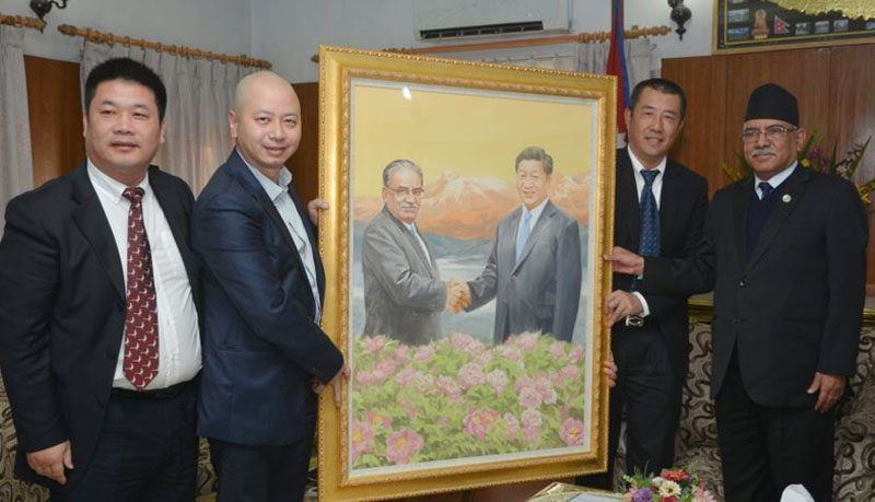 Prime Minister Pushpa Kamal Dahal receives a painting gifted by a team of Chinese artists at Baluwatar in Kathmandu on Tuesday, December 6, 2016. Photo: PM's Secretarit