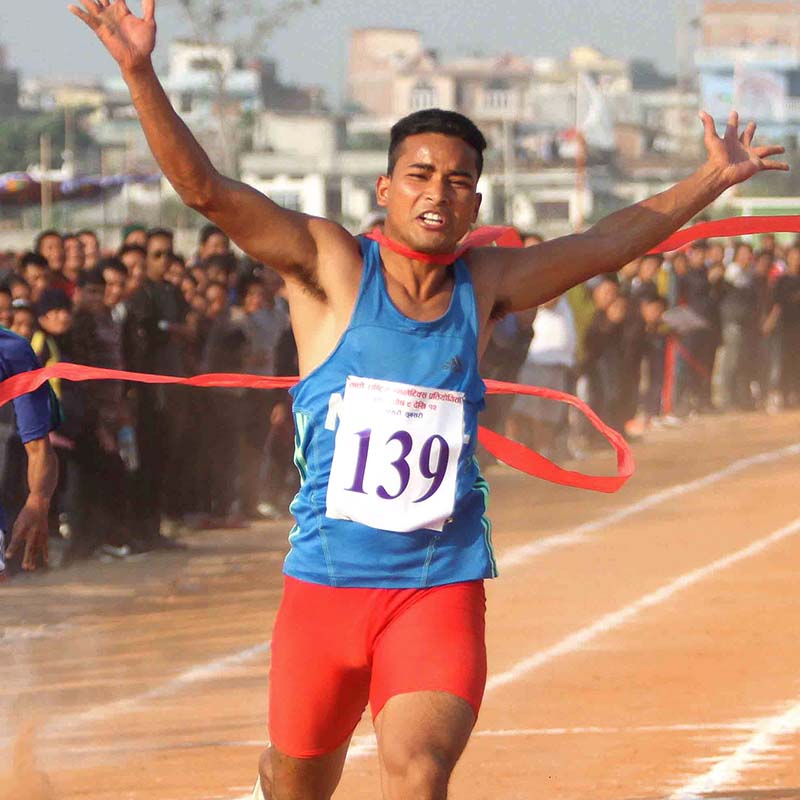 Yam Sajan Sunar of Mid-western Region celebrates after crossing finish line in men's 100m final race during the 7th National Games at the Itahari Rangasala in Sunsari, on Saturday, December 24, 2016. Photo: Udipt Singh Chhetry/THT