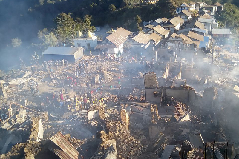 The Sankranti Bazaar market area is seen in rubble as a fire breaks out, in Terhathum district, on Friday, on Friday, December 16, 2016. Photo: Amrit Banstola