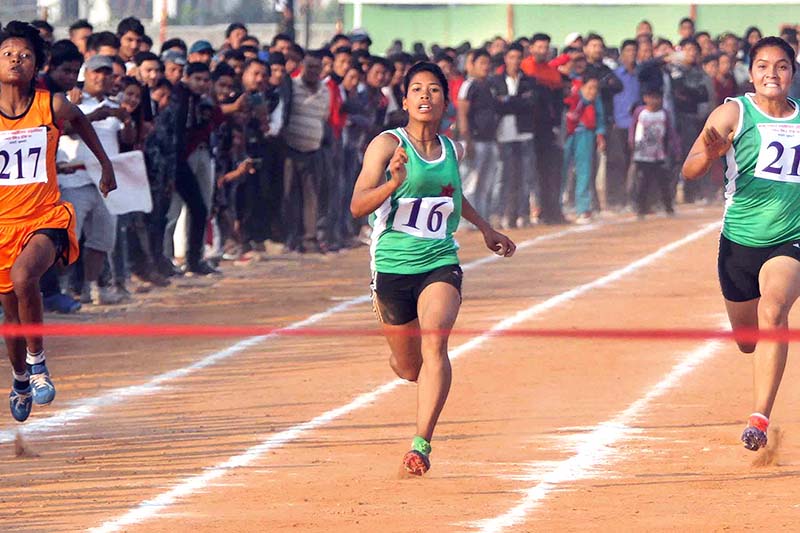 Krishna Chaudhary (centre) of the Tribhuvan Army Club runs in women's 100m final race during the 7th National Games at the Itahari Rangasala in Sunsari, on Saturday. Photo: Udipt Singh Chhetry/THT