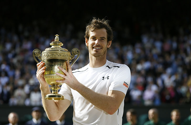 FILE - Andy Murray of Britain holds the trophy after beating Milos Raonic of Canada in the men's singles final at Wimbledon Tennis Championships in London. Murray is to receive an OBE for services to tennis and charity, in the Queen's 2017 New Year honors, on Sunday, July 10, 2016. Photo: AP