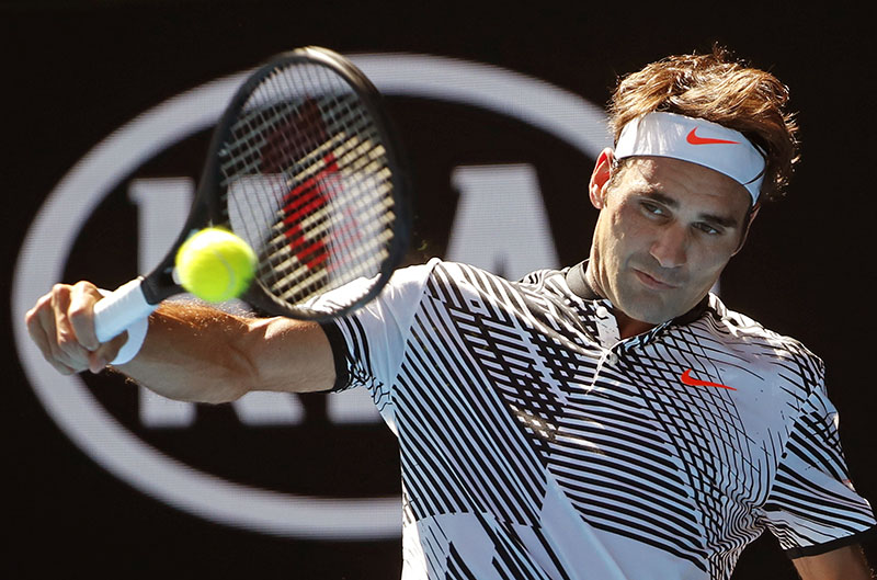 Switzerland's Roger Federer makes a backhand return to United States' Noah Rubin during their second round match at the Australian Open tennis championships in Melbourne, Australia, on Wednesday, January 18, 2017. Photo: AP