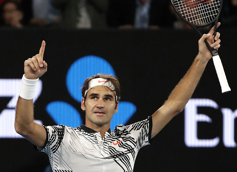 Switzerland's Roger Federer celebrates after defeating compatriot Stan Wawrinka during their semifinal at the Australian Open tennis championships in Melbourne, Australia, on Thursday, January 26, 2017. Photo: AP
