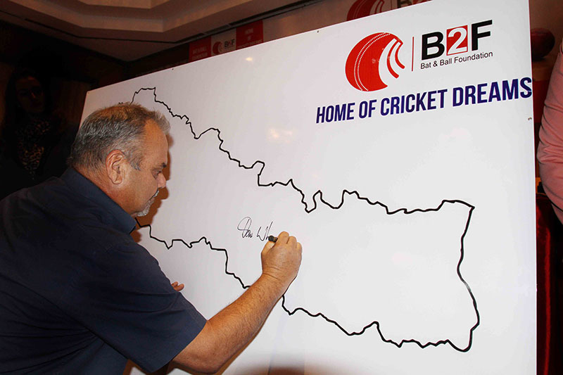 Australian coach Dav Whatmore signs on the map of Nepal during the launching ceremony of the Bat and Ball Foundation in Lalitpur on Monday, January 23, 2017. Photo: Udipt Singh Chhetry/THT