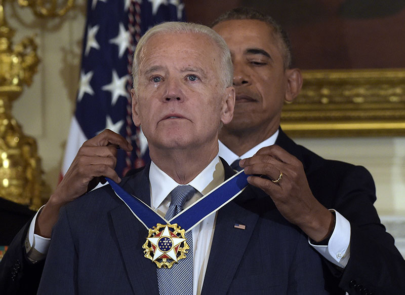 President Barack Obama presents Vice President Joe Biden with the Presidential Medal of Freedom during a ceremony in the State Dining Room of the White House in Washington, on Thursday, January 12, 2017. Photo: AP