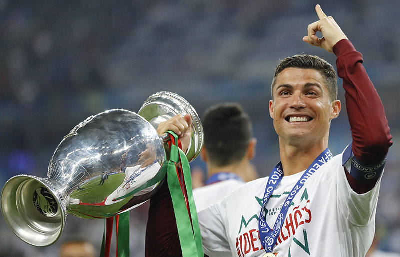 FILE - Portugal's Cristiano Ronaldo celebrates with the trophy at the end of the Euro 2016 final soccer match between Portugal and France at the Stade de France in Saint-Denis, north of Paris, on Sunday, July 10, 2016. Photo: AP