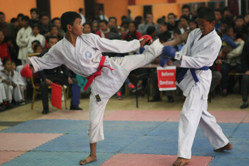 Dinesh Tamang (left) of Nageshwor fights against Aashish Lama of Sundarijal during their 40kg nsection bout of third Sagarmatha International Karate Championship in Kathmandu on Wednesday, January 11, 2016. Photo: Udipt Singh Chhetry/THT