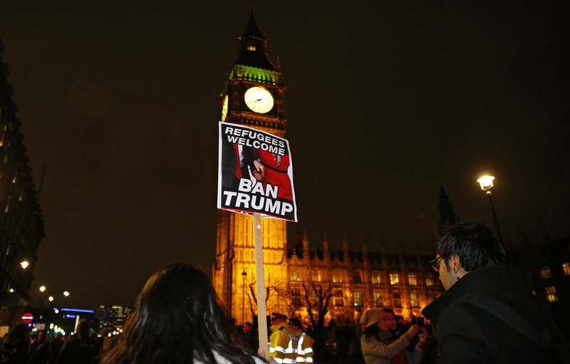 Demonstrators hold a banner during a protest against US President Donald Trump's controversial travel ban on refugees and people from seven mainly-Muslim countries, in London, Monday, Jan. 30, 2017. Photo: AP