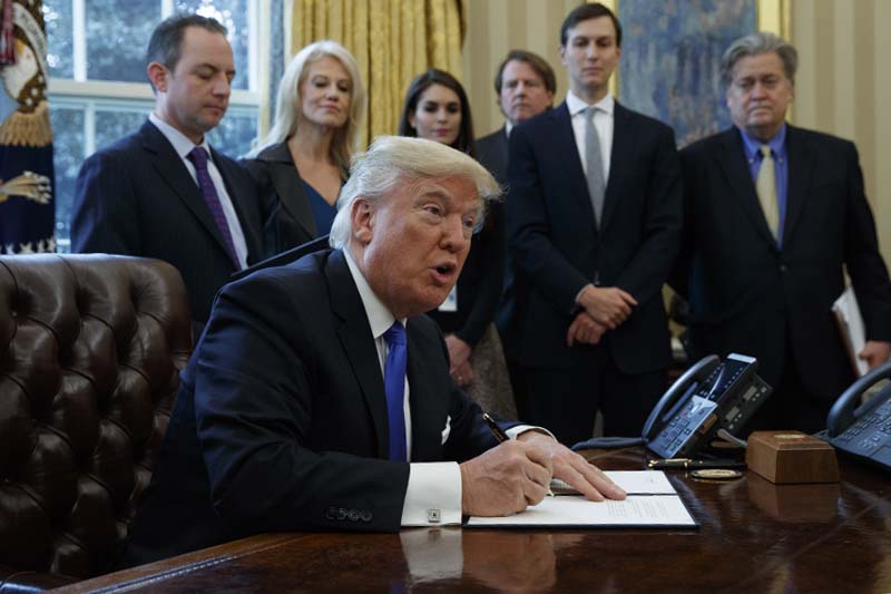 US President Donald Trump signs an executive order on the Keystone XL pipeline, in the Oval Office of the White House in Washington, on Tuesday, January 24, 2017. Photo: AP