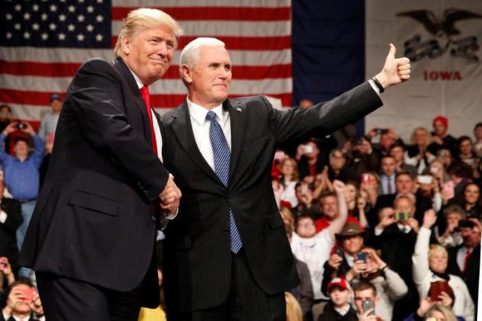 U.S. President-elect Donald Trump shakes hands with Vice President-elect Mike Pence (R) at the USA Thank You Tour event at the Iowa Events Center in Des Moines, Iowa, U.S., December 8, 2016. REUTERS/Shannon Stapleton