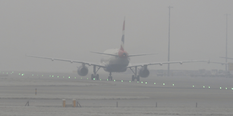A British Airways plane is seen through dense fog on the tarmac at Heathrow Airport, London, Monday, Jan. 23, 2017. Photo: AP