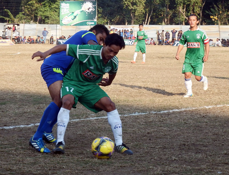 Players of Nepal Police Club and Sahara Club (front) fight for the ball during their Tuborg nHetauda Gold Cup match in Makawanpur on Saturday, December 31, 2016. Photo: THT