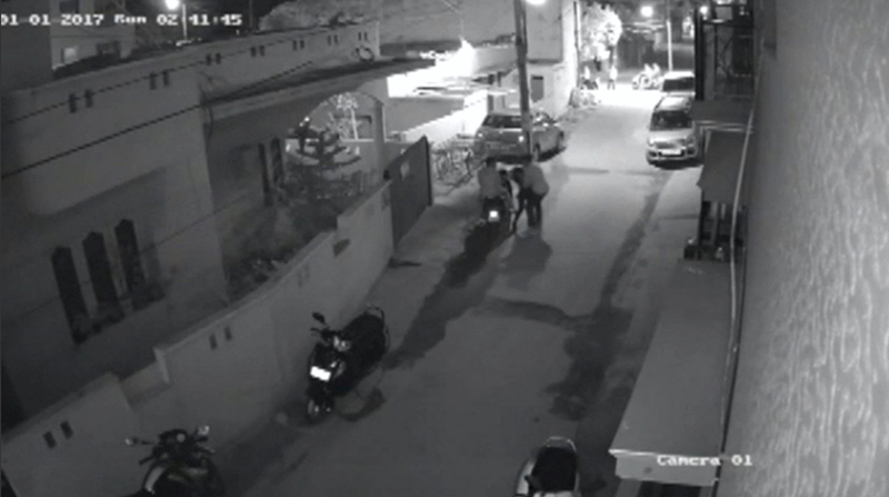 Two men on a scooter assault a woman, attempting to take off her clothes and pushing her to the ground before leaving, in Bengaluru, India, in this still image taken from January 1, 2017 CCTV footage. Image: Local Resident CCTV footage/via Reuters TV