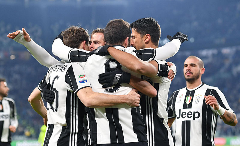 Juventus's Gonzalo Higuain (centre) with back to camera, celebrates with teammates after scoring during a Serie A soccer match between Juventus and Bologna at Juventus Stadium in Turin, Italy, on Sunday, January 8, 2017.  Photo: Alessandro Di Marco/ANSA via AP