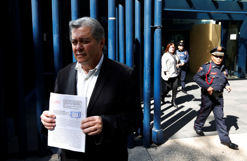 Jaime Martinez, head of the federally-run Commission for Dialogue with Indigenous People stands outside the Mexico's attorney general's office as he holds his complaint against Trump in Mexico City, Mexico on January 25, 2017. Photo: Reuters