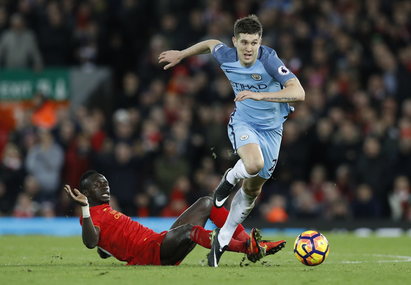 Liverpool's Sadio Mane in action with Manchester City's John Stones. Photo: Reuters