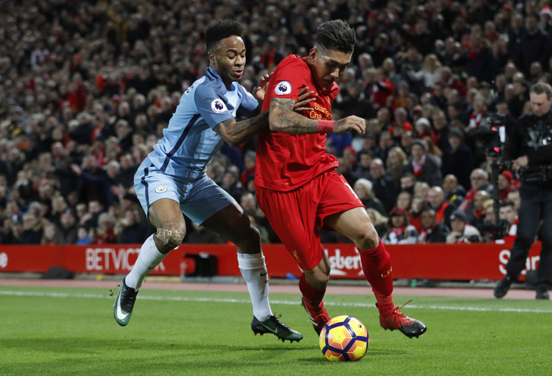 Manchester City's Raheem Sterling in action with Liverpool's Roberto Firmino. Photo: Reuters