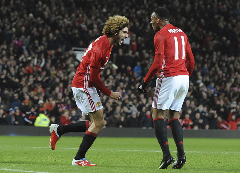 Manchester United's Marouane Fellaini (left) celebrates after scoring his sides second goal during the English League Cup semi-final, 1st leg, soccer match between Manchester United and Hull at Old Trafford stadium in Manchester, England, on Tuesday, January 10, 2017. Photo: AP