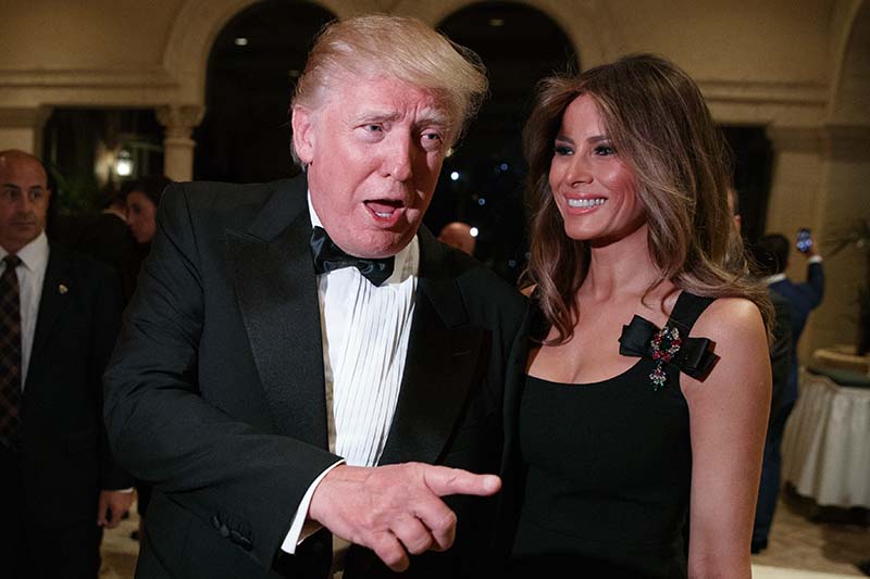 Melania Trump (right) looks on as her husband US President-elect Donald Trump talks to reporters during a New Year's Eve party at Mar-a-Lago, in Palm Beach, Florida, on Saturday, December 31, 2016. Photo: AP