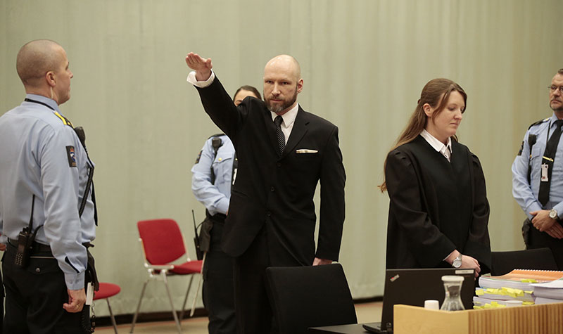 Anders Behring Breivik raises his right hand at the start of his appeal case in Borgarting Court of Appeal at Telemark prison in Skien, Norway, on Tuesday, January 10, 2017. Photo: Lise Aaserud/NTB Scanpix via AP