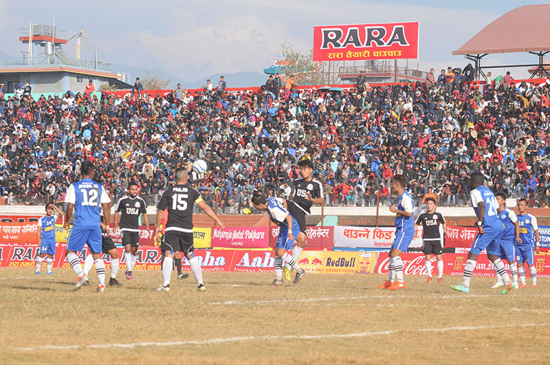 Players of Rumpum Jhapa-XI and ANA-USA Football Club (in black jersey) in action during their 15th Aaha-Rara Gold Cup match at the Pokhara Stadium on Thursday, January 19, 2017. Photo: THT