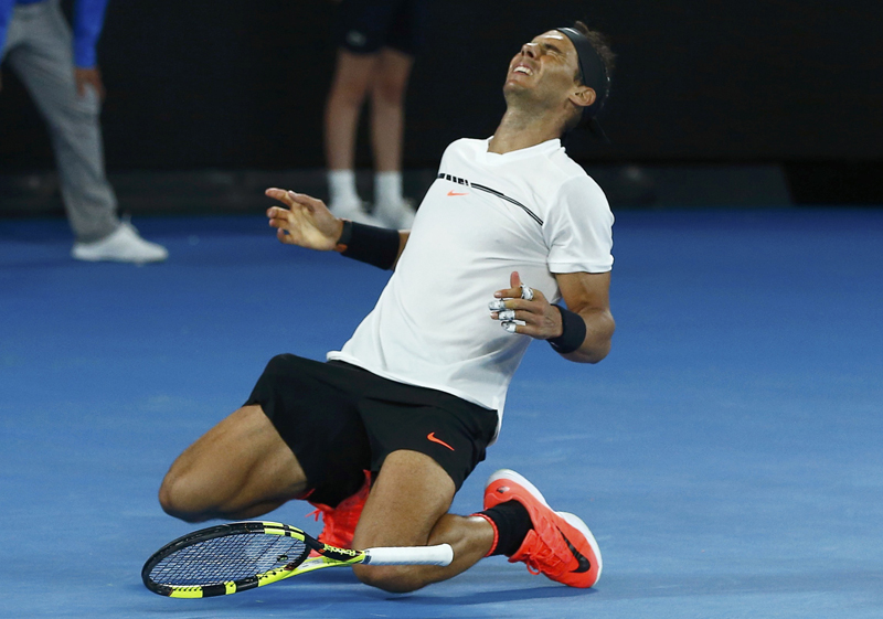 Spain's Rafael Nadal falls onto the court as he celebrates winning his Men's singles semi-final match against Bulgaria's Grigor Dimitrov. Photo: Reuters