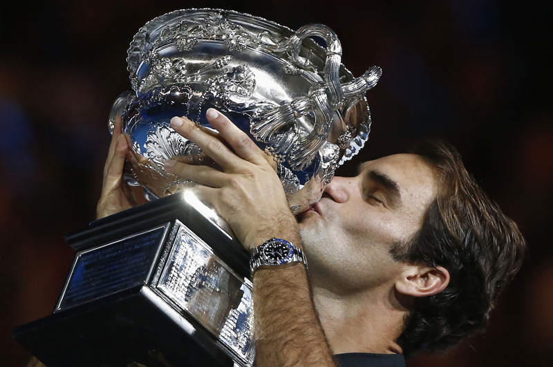 Switzerland's Roger Federer kisses the trophy after winning his Men's singles final match against Spain's Rafael Nadal. Photo: Reuters