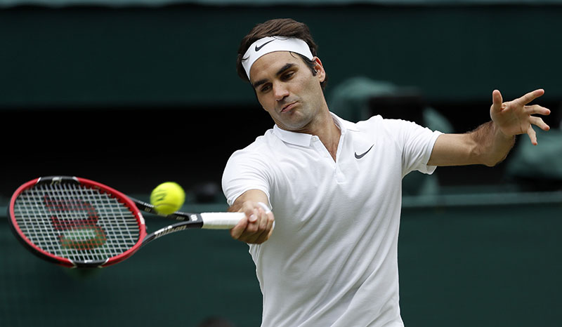 FILE - Roger Federer of Switzerland returns to Milos Raonic of Canada during their men's semifinal singles match at the Wimbledon Tennis Championships in London, on July 8, 2016. Photo: AP