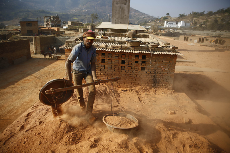 A worker unloads mud at a brick kiln in Lalitpur on Tuesday, January 24, 2017. Photo: Skanda Gautam