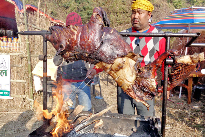 A vendor barbecues a pig at a local festival on the Maikhola riverbank in Ilam distict, on Sunday, January 15, 2017. Photo: RSS