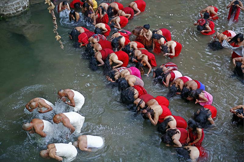 Hindu devotees take a holy dip at the Shalinadi River, on the first day of the month-long Swasthani Brata Katha festival, at Sankhu in Kathmandu, on Thursday, January 12, 2017. Photo: Skanda Gautam/THT